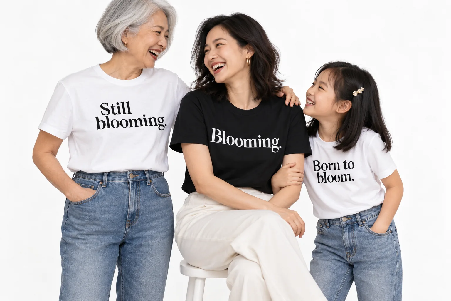 Campaign photo: a grandmother, mother and daughter sharing a laugh in Still blooming., Blooming. and Born to bloom. T-shirts